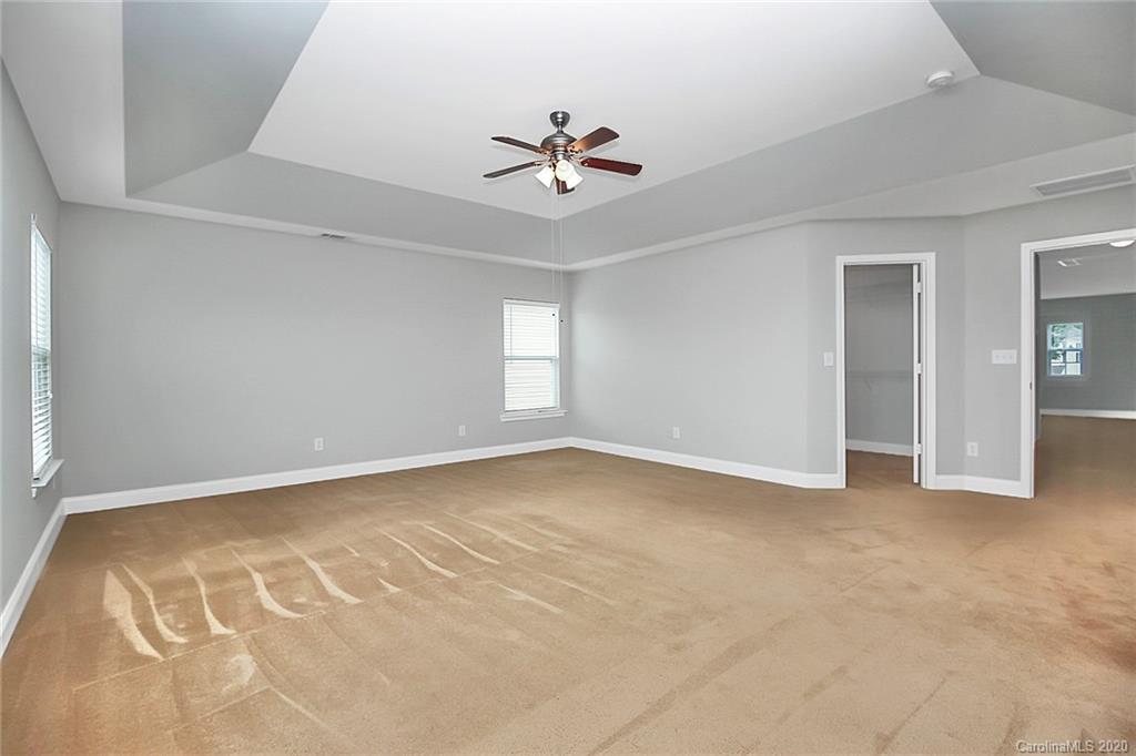 9522 Seamill Road Charlotte, NC 28278 - Photo 28 of 43 an empty room with a ceiling fan and window