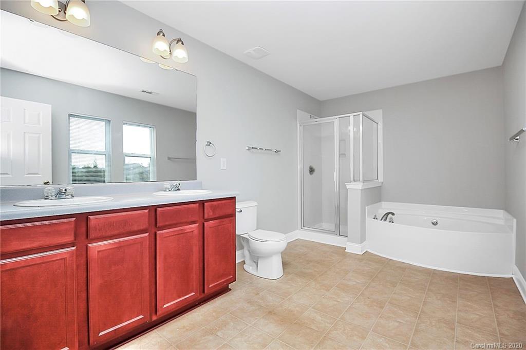 9522 Seamill Road Charlotte, NC 28278 - Photo 30 of 43 a spacious bathroom with a tub sink mirror and a toilet