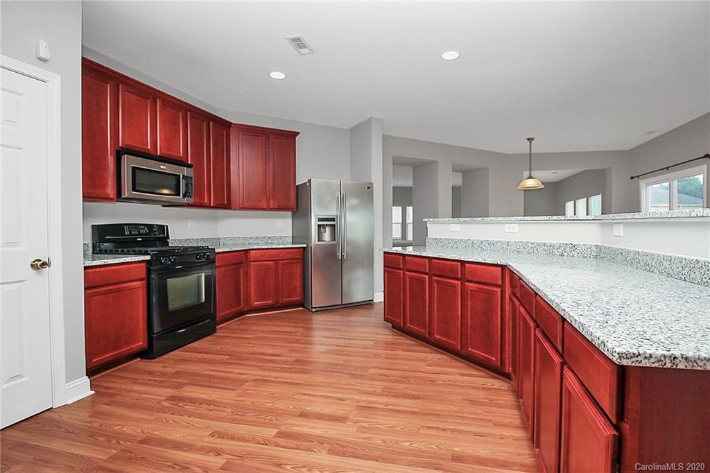 9522 Seamill Road Charlotte, NC 28278 - Photo 4 of 43 a kitchen with stainless steel appliances granite countertop a stove a sink dishwasher and a refrigerator
