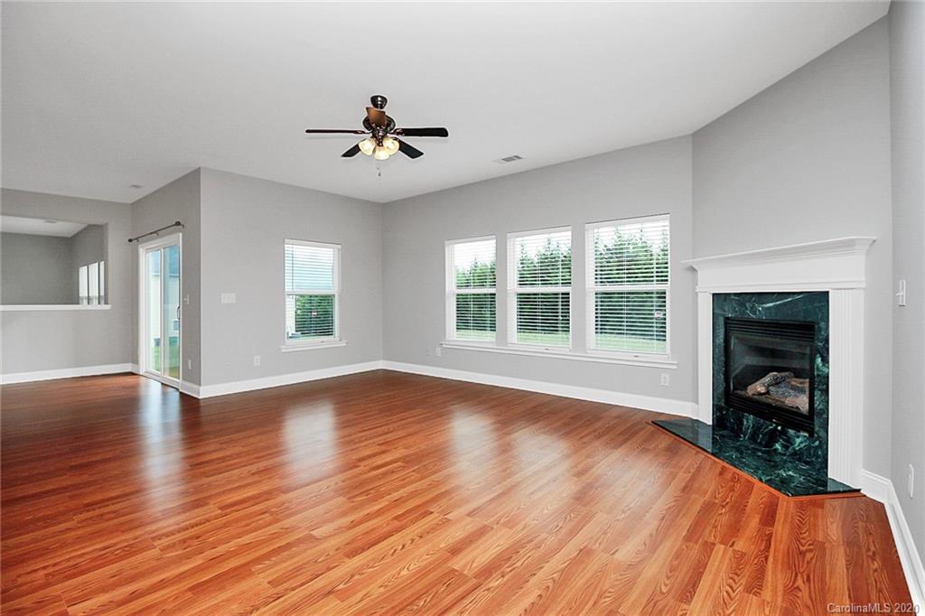 9522 Seamill Road Charlotte, NC 28278 - Photo 5 of 43 a view of empty room with wooden floor and fireplace