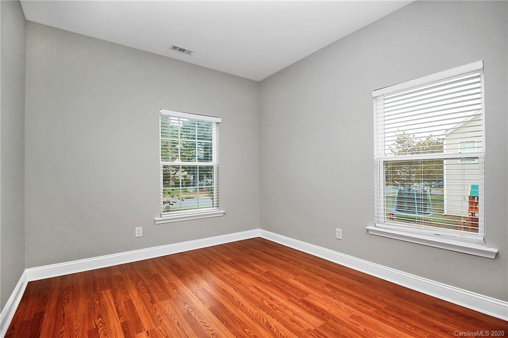 9522 Seamill Road Charlotte, NC 28278 - Photo 6 of 43 a view of an empty room with wooden floor and a window