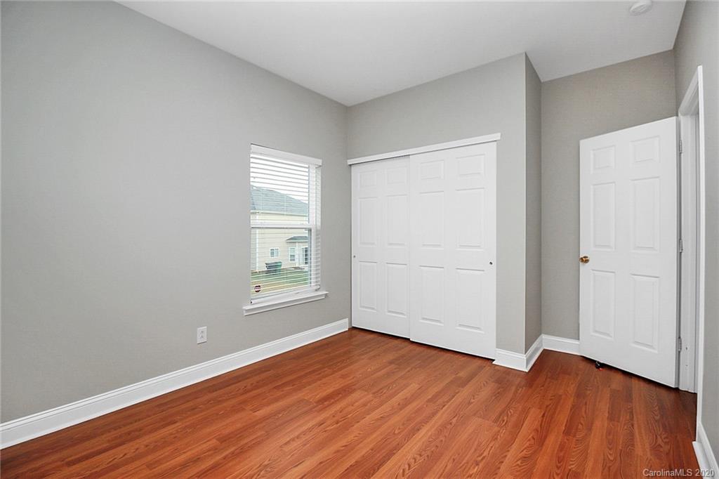 9522 Seamill Road Charlotte, NC 28278 - Photo 7 of 43 an empty room with wooden floor and windows