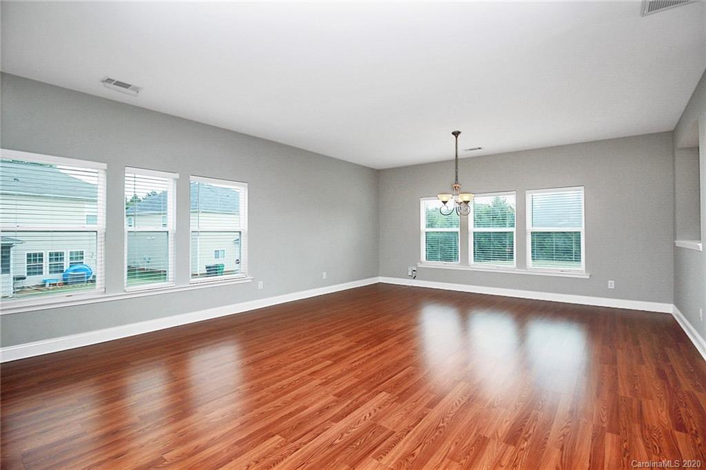 9522 Seamill Road Charlotte, NC 28278 - Photo 8 of 43 a view of an empty room with wooden floor and a window