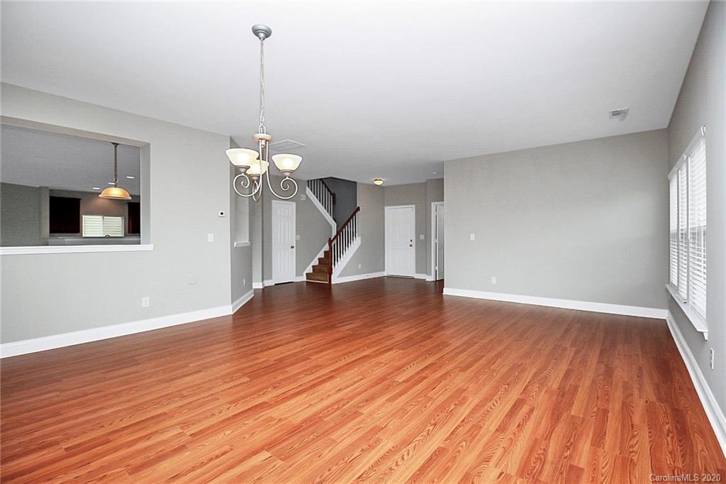 9522 Seamill Road Charlotte, NC 28278 - Photo 10 of 43 a view of empty room with wooden floor and fan