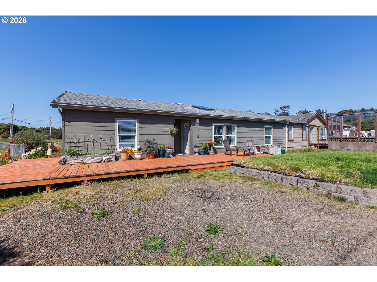 2018 Northwest Oceanic Loop Waldport, OR 97394 - Photo 32 of 35 a view of a house with backyard porch and furniture