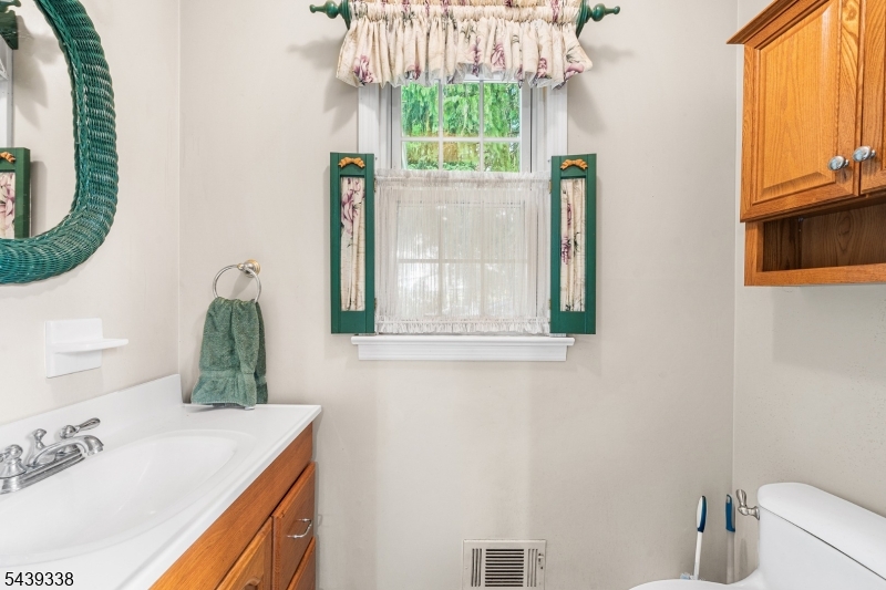 1 Oak Grove Road Flemington, NJ 08822 - Photo 14 of 29 a bathroom with a sink and a mirror