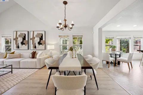 a living room with furniture chandelier and a window