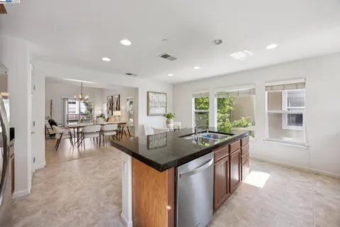 a kitchen with granite countertop a center island and some appliances