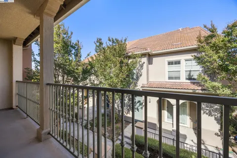 a view of a balcony with a tree