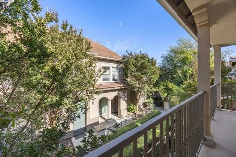 a balcony with trees in front of it