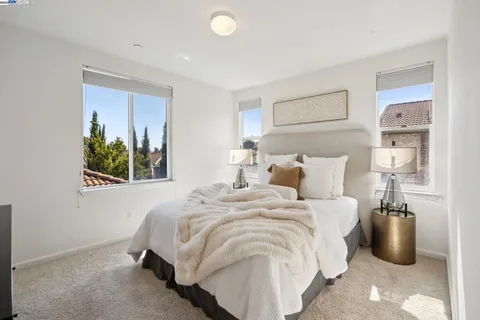 a bedroom with bed and a window