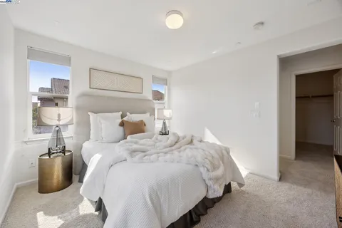 a bedroom with bed and a night stand