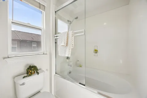 a bath room with a bath tub and a shower