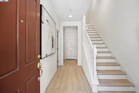a view of entryway with wooden floor and stairs