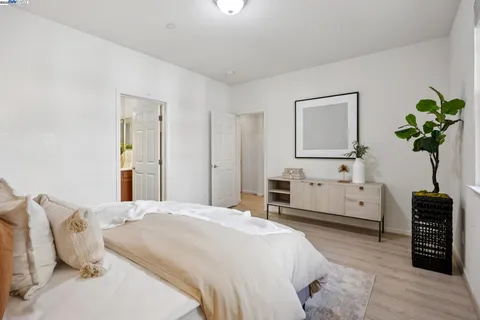 a bedroom with a bed and a potted plant