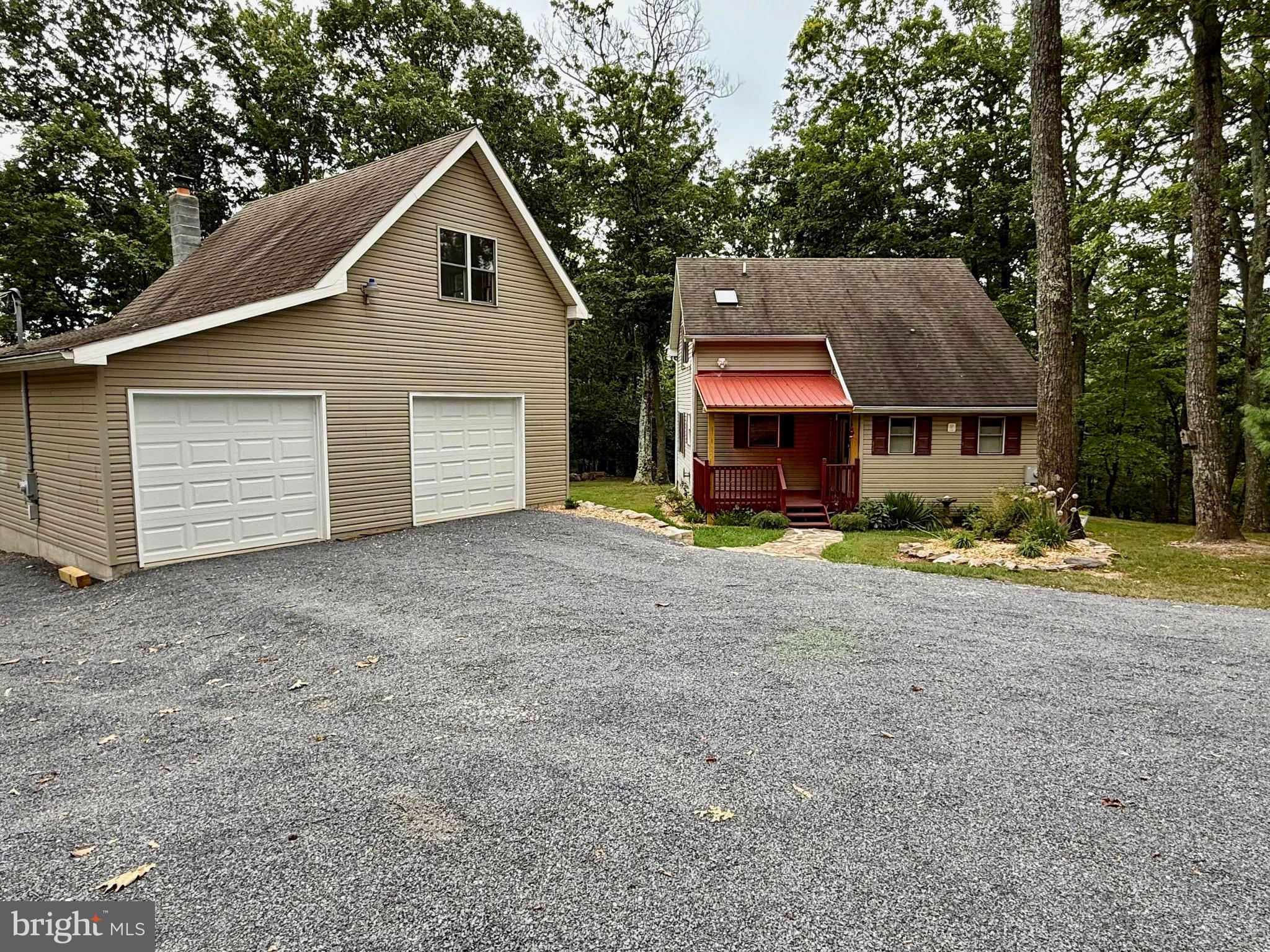 348 Trapper Ridge Lane Hedgesville, WV 25427 - Photo 2 of 41 a view of a house with a yard and large tree