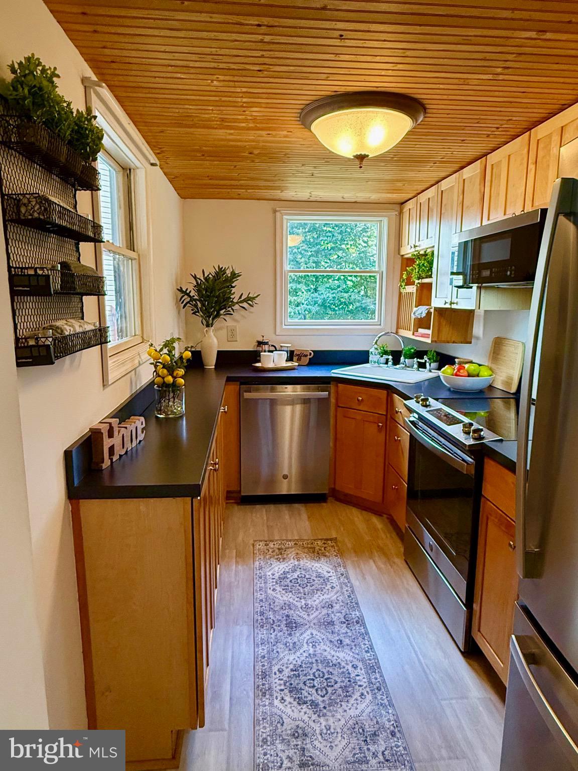 348 Trapper Ridge Lane Hedgesville, WV 25427 - Photo 7 of 41 a kitchen with stainless steel appliances granite countertop a sink stove and cabinets