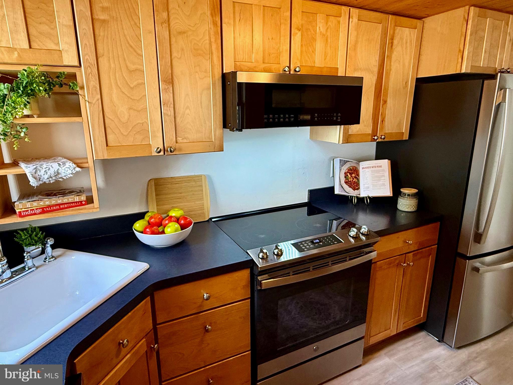 348 Trapper Ridge Lane Hedgesville, WV 25427 - Photo 8 of 41 a kitchen with stainless steel appliances a stove a microwave a refrigerator and a stove
