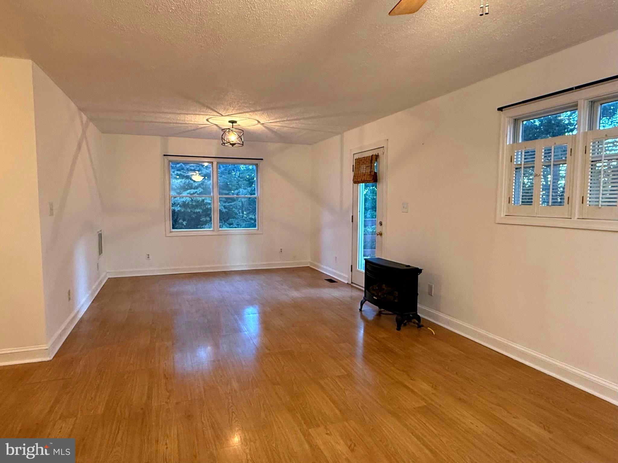 348 Trapper Ridge Lane Hedgesville, WV 25427 - Photo 9 of 41 a view of an empty room with wooden floor and a window
