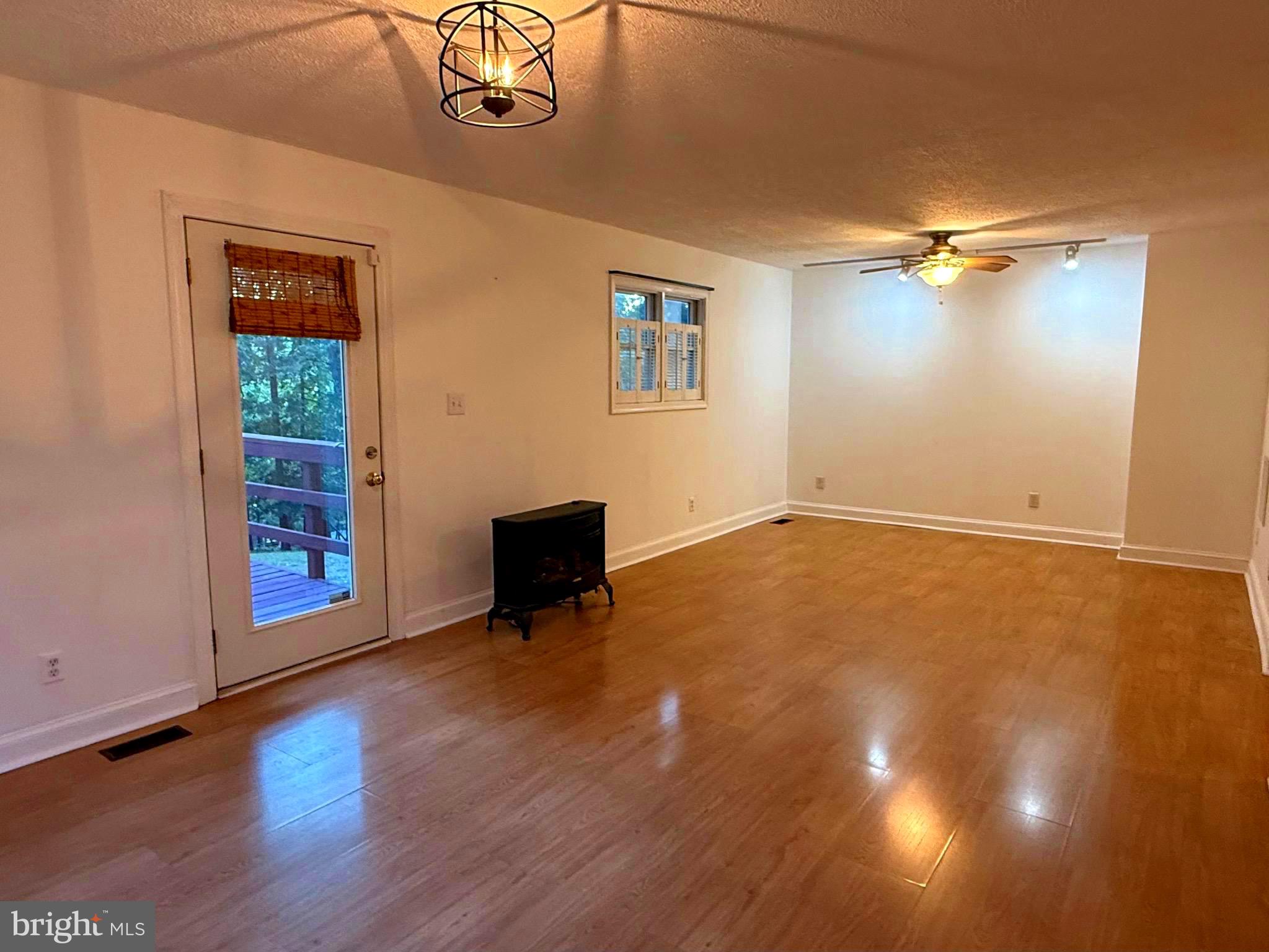 348 Trapper Ridge Lane Hedgesville, WV 25427 - Photo 10 of 41 wooden floor in an empty room with a window