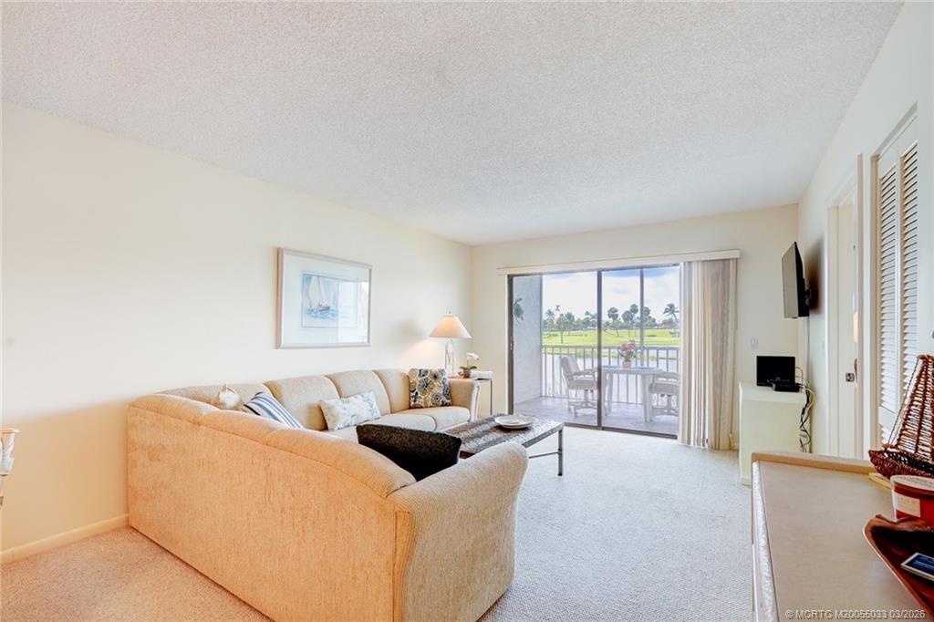 5593 Northeast Gulfstream Way Jensen Beach, FL 34957 - Photo 11 of 39 a living room with furniture and a large window