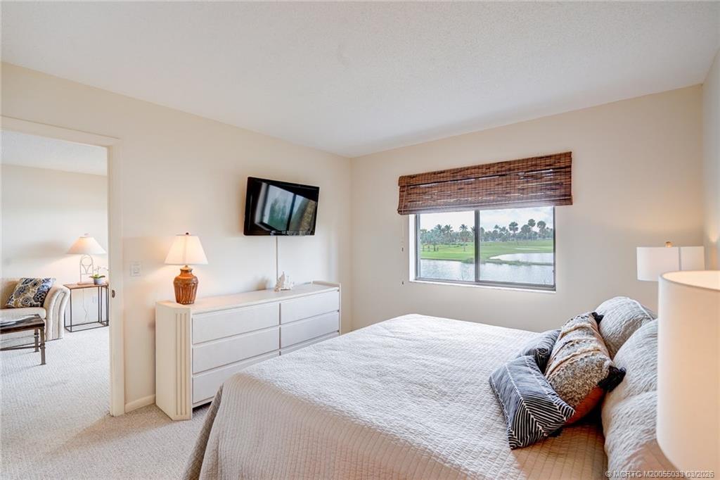 5593 Northeast Gulfstream Way Jensen Beach, FL 34957 - Photo 21 of 39 a bedroom with a bed and tv