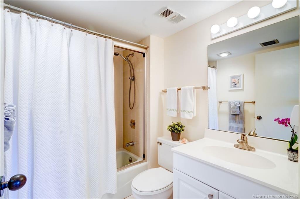 5593 Northeast Gulfstream Way Jensen Beach, FL 34957 - Photo 30 of 39 a bathroom with a sink toilet and shower