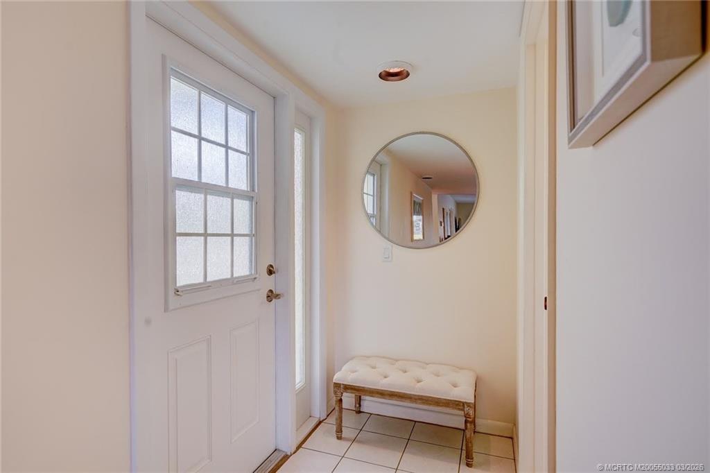 5593 Northeast Gulfstream Way Jensen Beach, FL 34957 - Photo 32 of 39 a bathroom with a toilet a sink and a window