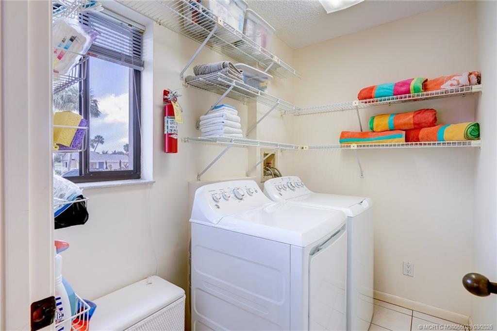 5593 Northeast Gulfstream Way Jensen Beach, FL 34957 - Photo 33 of 39 a utility room with dryer and washer