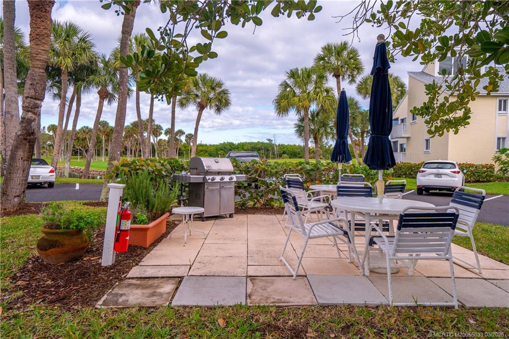 5593 Northeast Gulfstream Way Jensen Beach, FL 34957 - Photo 37 of 39 a view of a backyard with sitting area