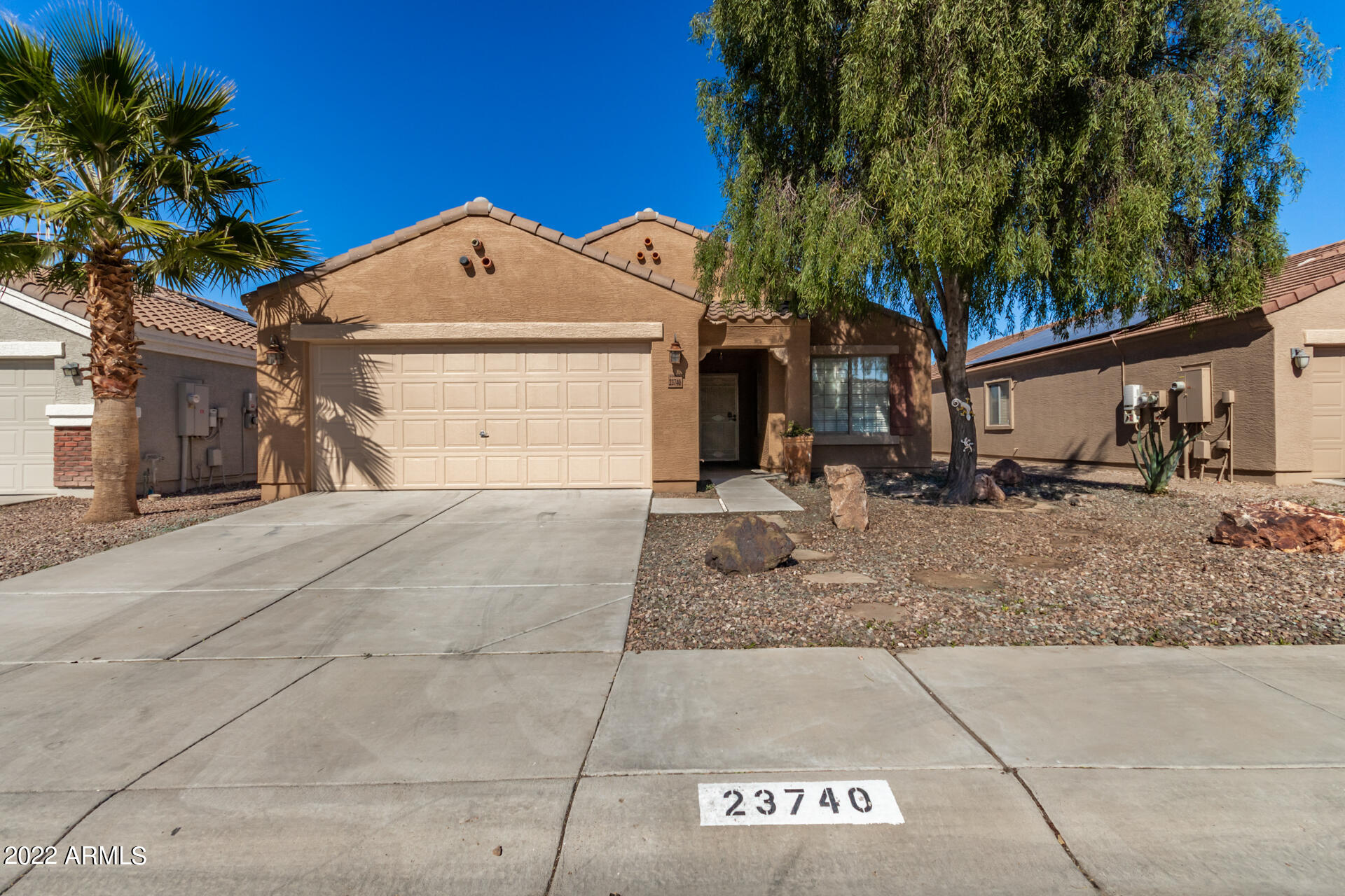 23740 West Grove Street Buckeye, AZ 85326 - Photo 1 of 23 a front view of a house with a yard and garage