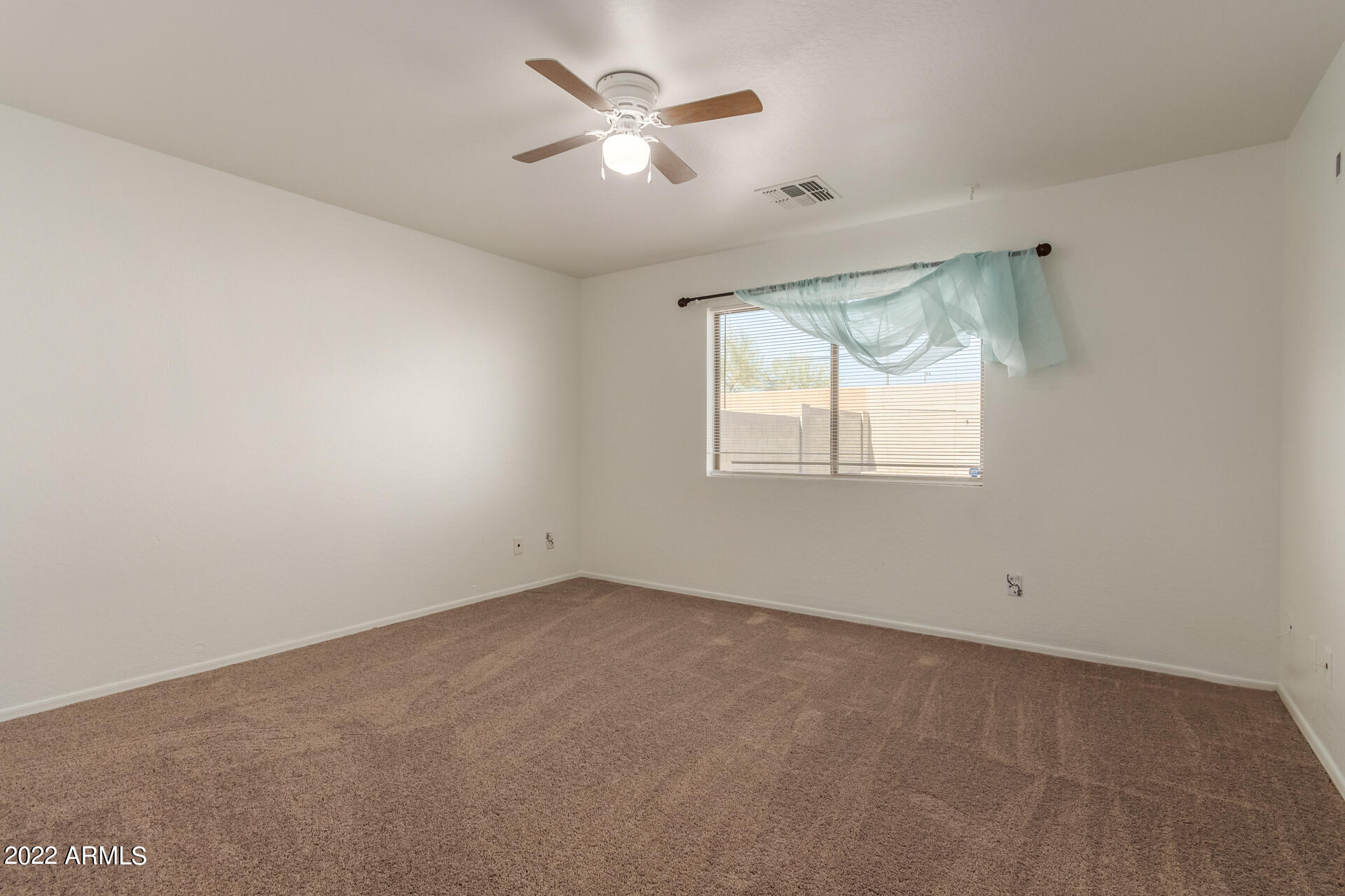 23740 West Grove Street Buckeye, AZ 85326 - Photo 11 of 23 an empty room with a window and a fan