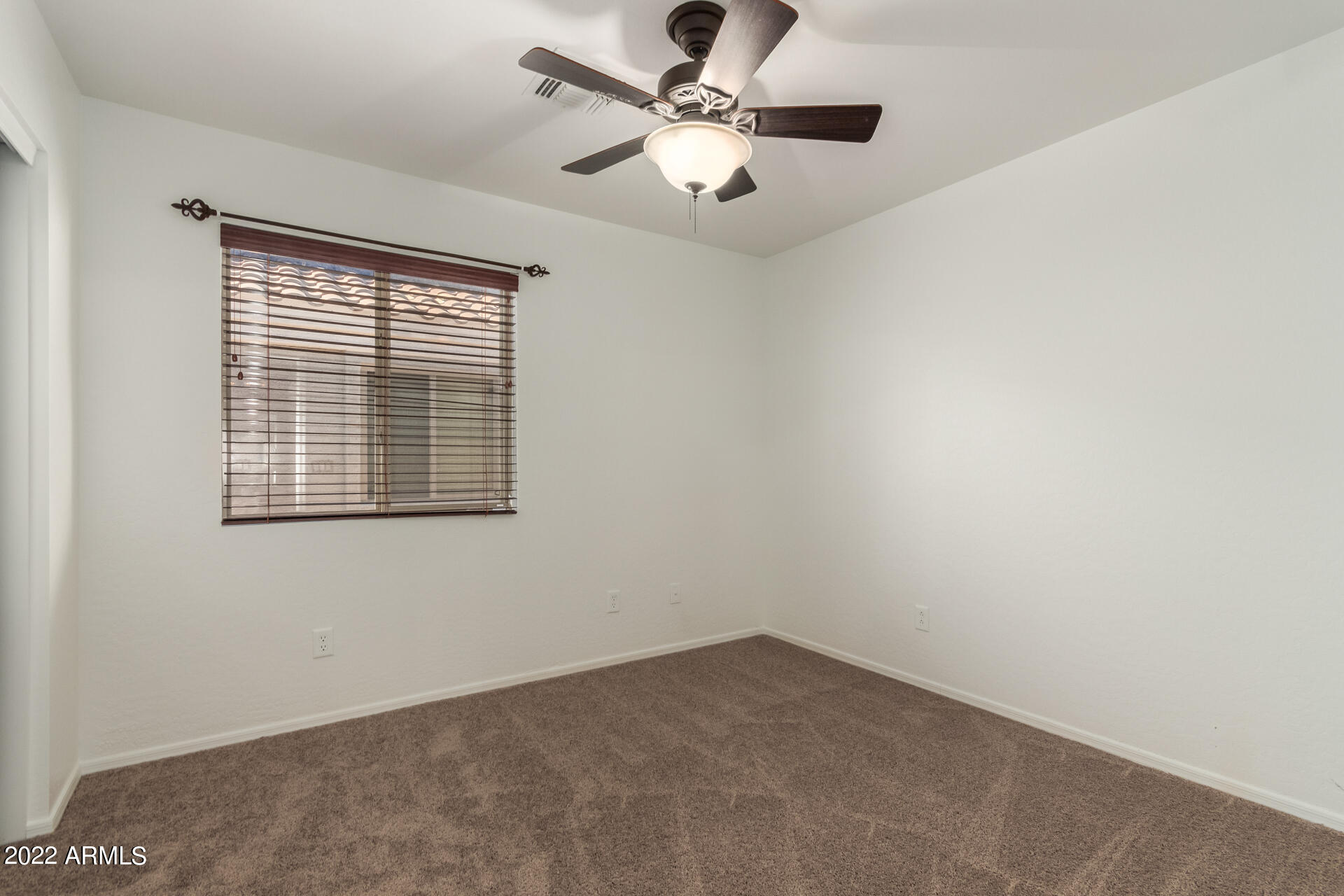 23740 West Grove Street Buckeye, AZ 85326 - Photo 15 of 23 an empty room with windows and fan