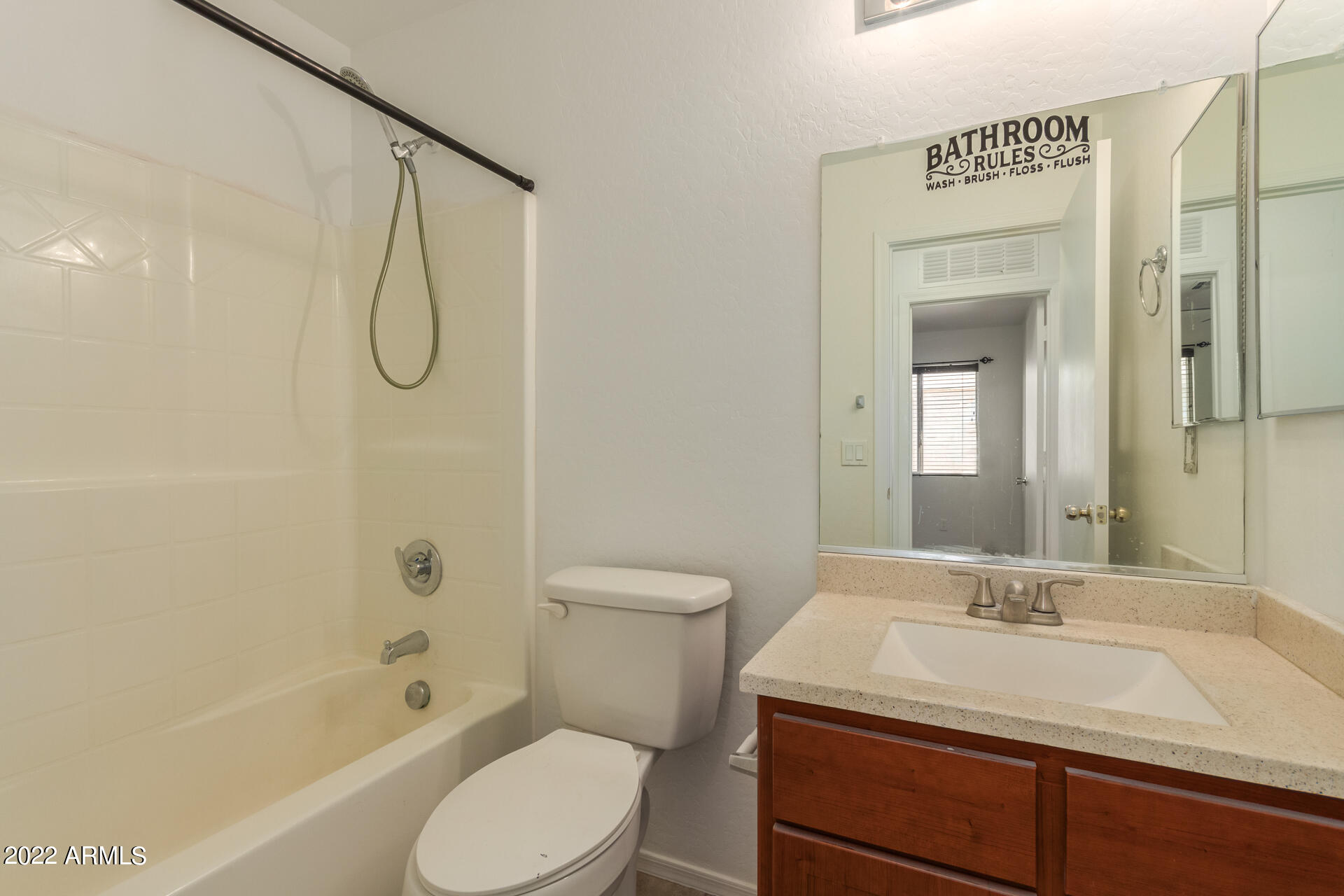 23740 West Grove Street Buckeye, AZ 85326 - Photo 16 of 23 a bathroom with a sink toilet vanity and shower