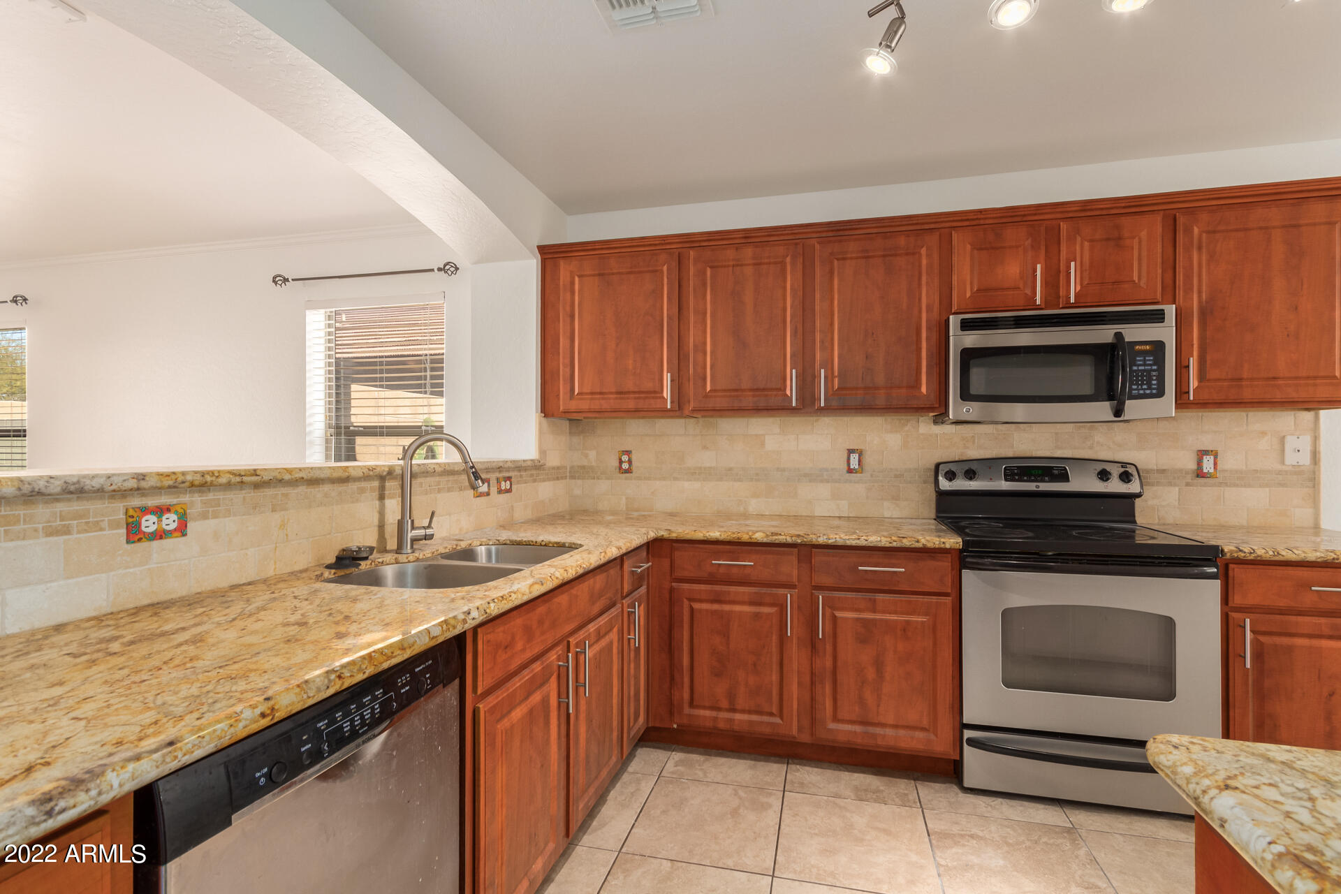 23740 West Grove Street Buckeye, AZ 85326 - Photo 4 of 23 a kitchen with a sink stove and microwave