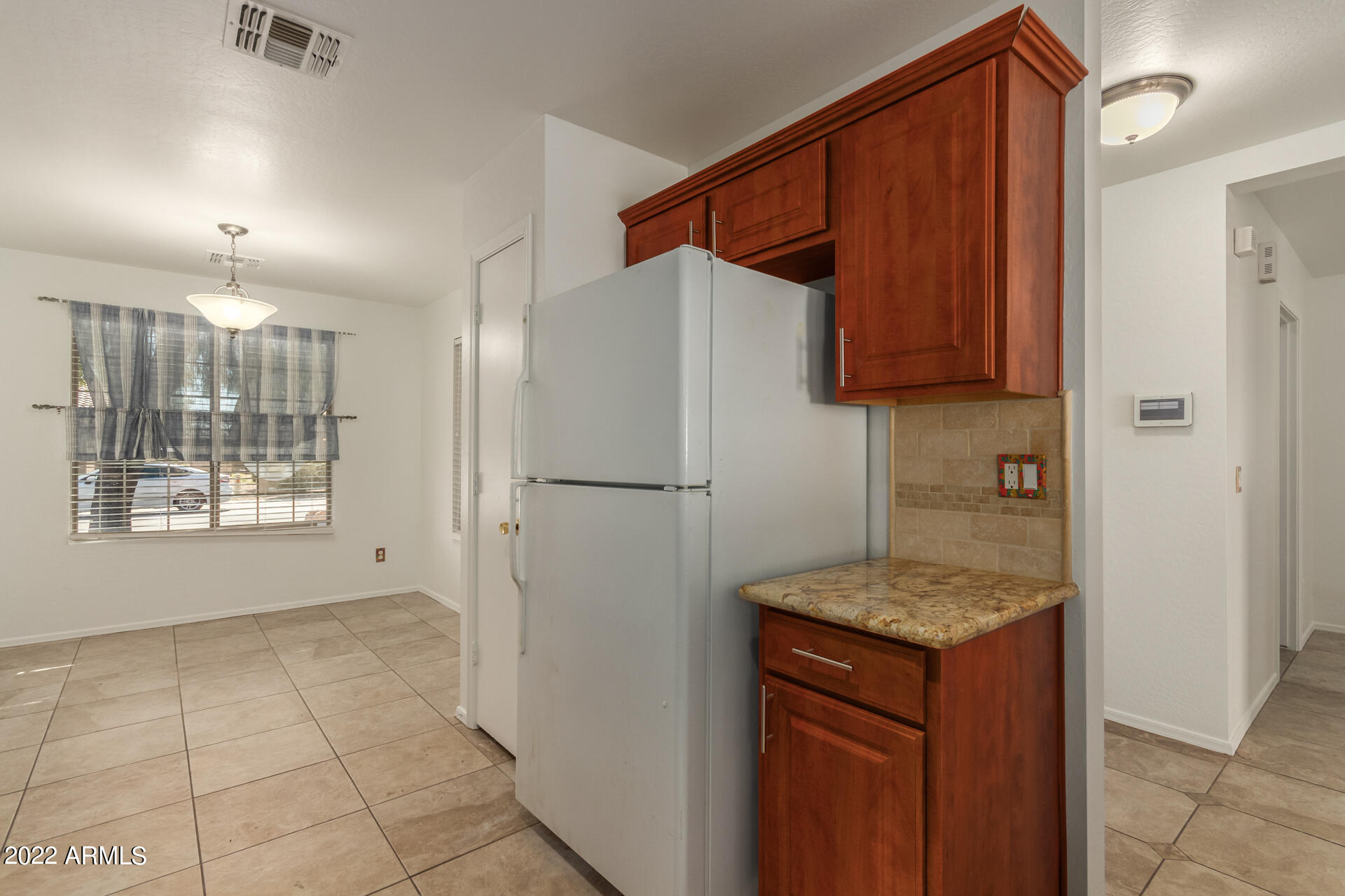 23740 West Grove Street Buckeye, AZ 85326 - Photo 5 of 23 a kitchen with a refrigerator and a sink