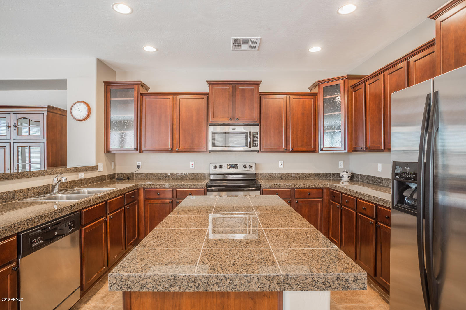 3101 South Joshua Tree Lane Gilbert, AZ 85295 - Photo 19 of 88 a kitchen with stainless steel appliances granite countertop a sink stove and refrigerator