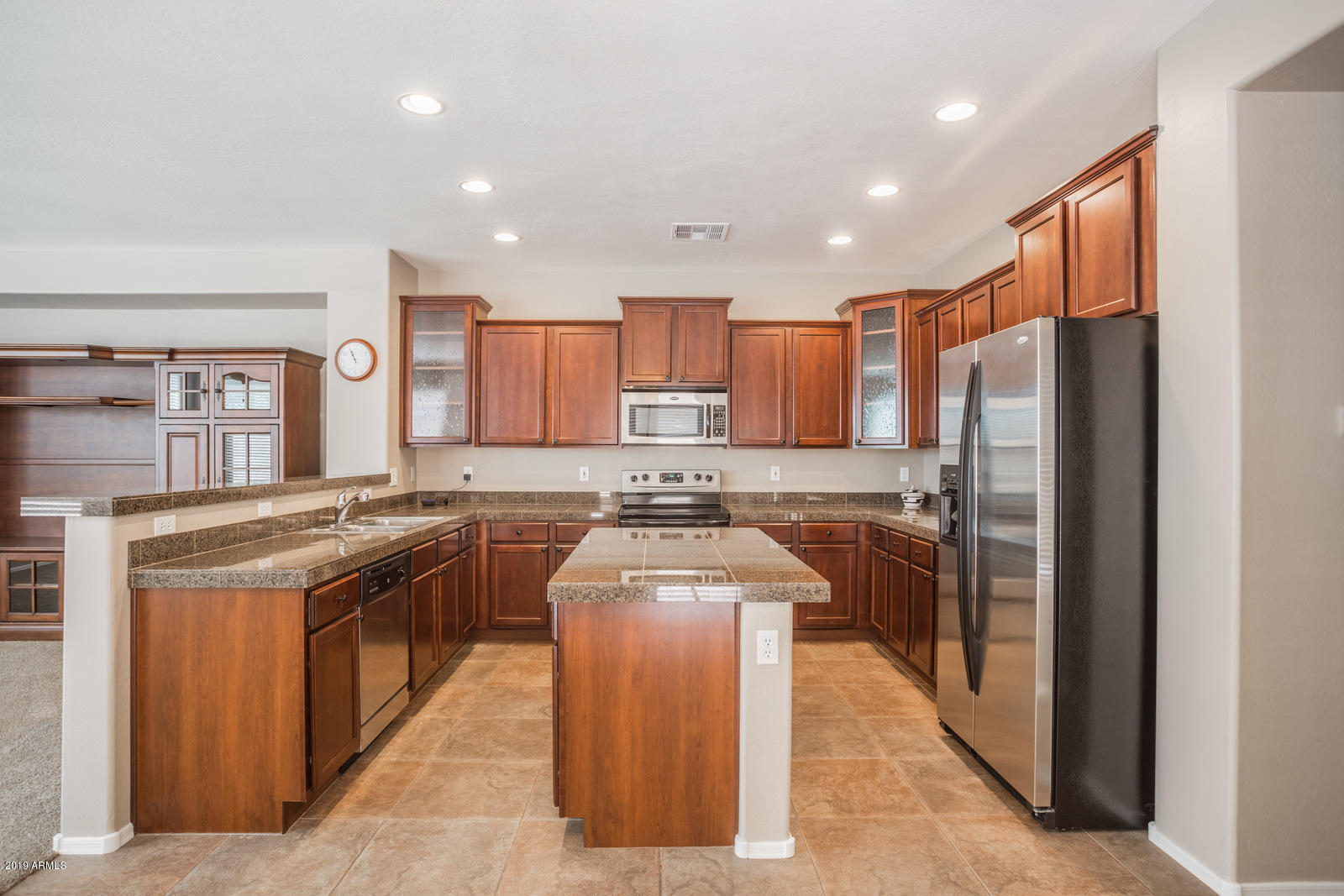 3101 South Joshua Tree Lane Gilbert, AZ 85295 - Photo 25 of 88 a kitchen with stainless steel appliances granite countertop a stove a sink and a refrigerator