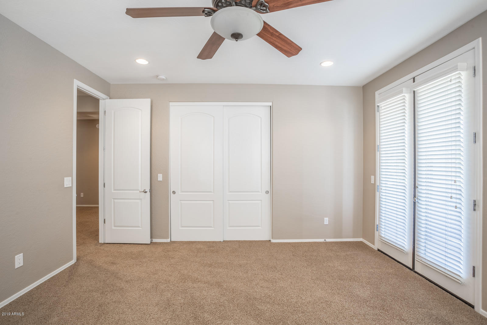 3101 South Joshua Tree Lane Gilbert, AZ 85295 - Photo 54 of 88 an empty room with chandelier fan and windows