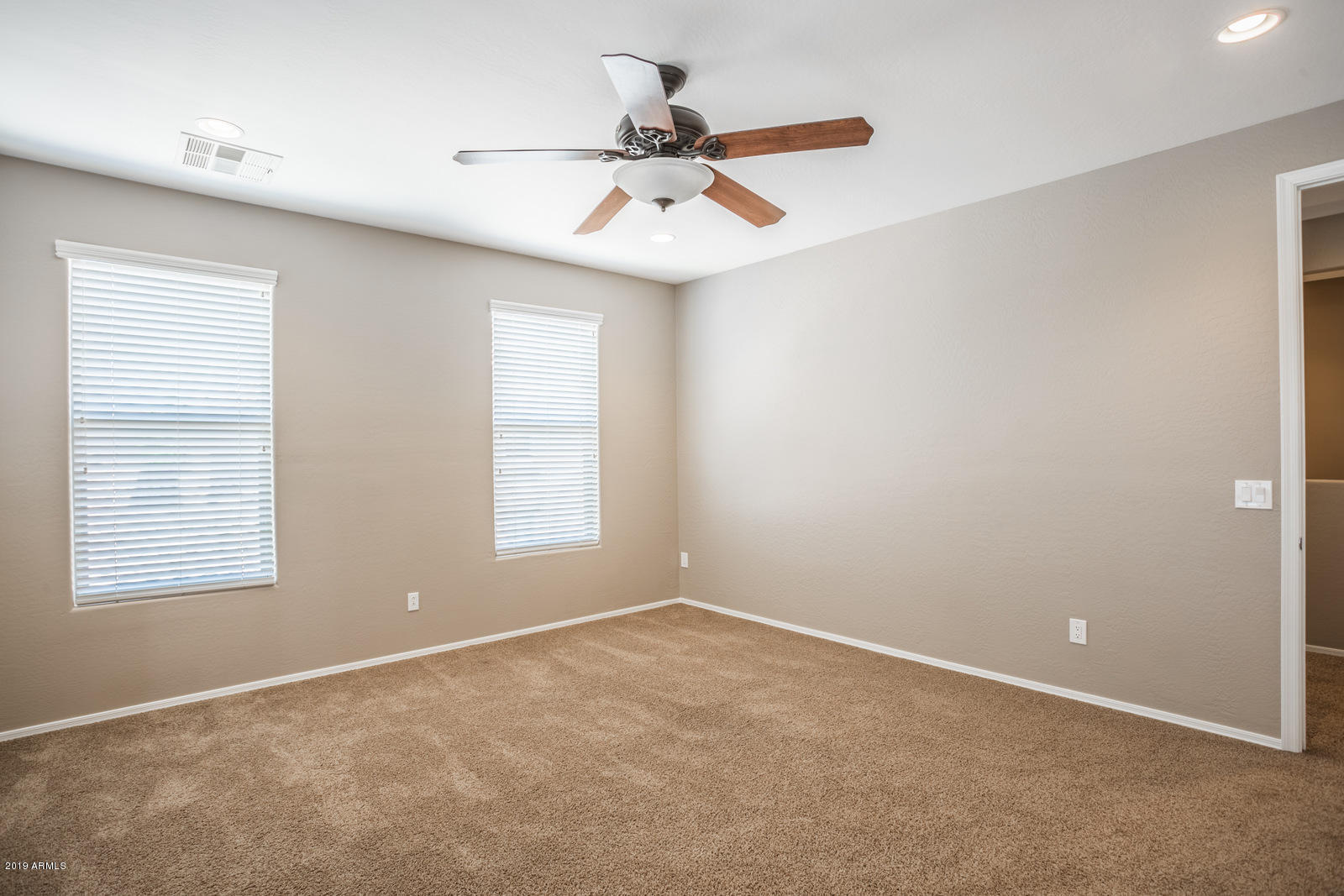 3101 South Joshua Tree Lane Gilbert, AZ 85295 - Photo 55 of 88 an empty room with a window and a fan