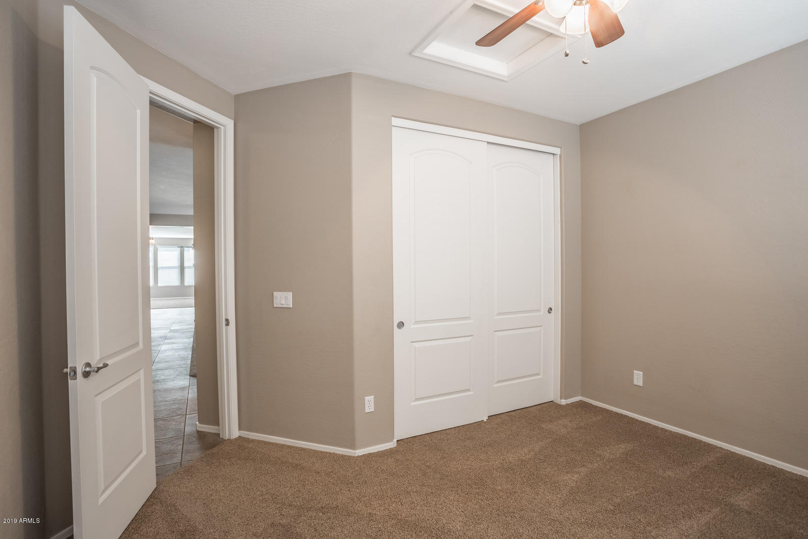 3101 South Joshua Tree Lane Gilbert, AZ 85295 - Photo 10 of 88 an empty room with closet and a chandelier fan