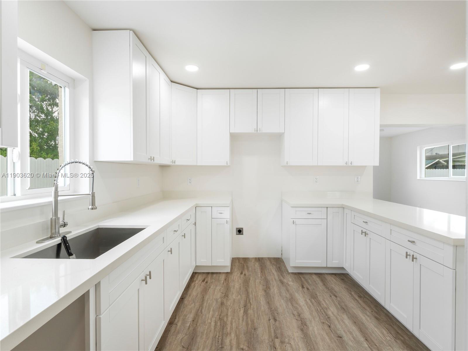 3051 Northwest 70th Terrace Miami, FL 33147 - Photo 18 of 32 a kitchen with sink cabinets and window