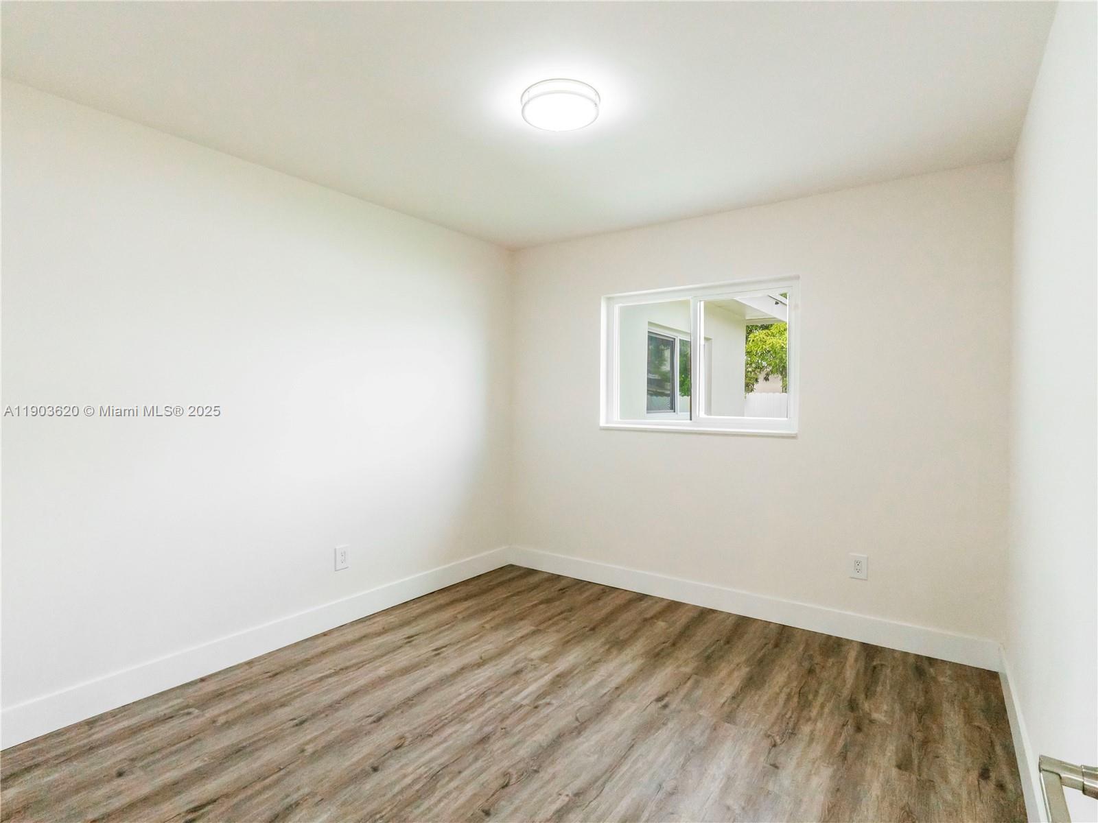 3051 Northwest 70th Terrace Miami, FL 33147 - Photo 24 of 32 an empty room with a window