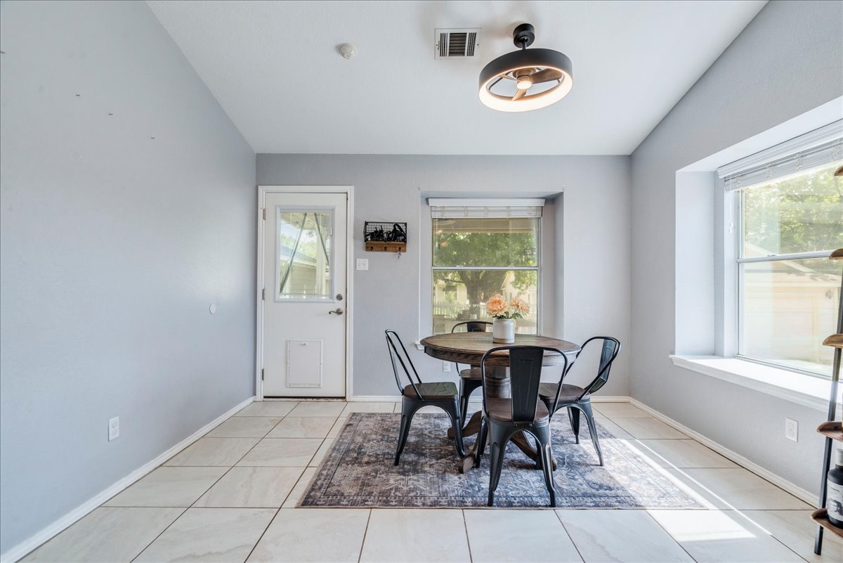 175 Wetzel Kyle, TX 78640 - Photo 13 of 27 A well-lit dining area featuring tiled flooring and a view of the outdoors.