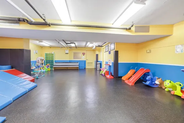 a room with gym equipment and floor to ceiling window