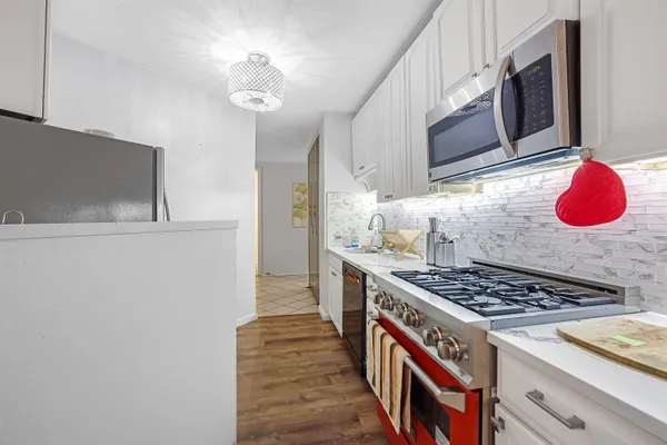 a kitchen with a sink stove and refrigerator