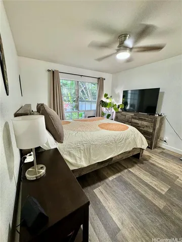 a bedroom with double bed and a flat tv screen