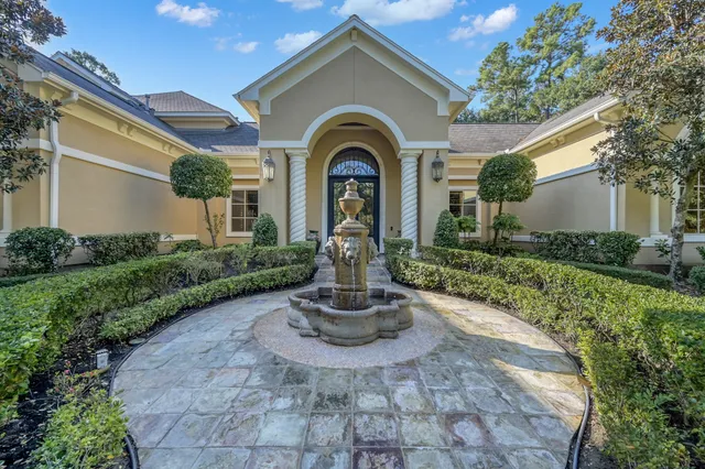 a front view of a house with garden