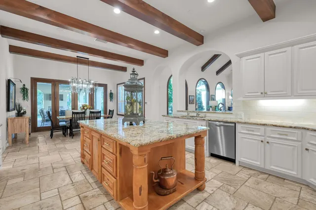 a kitchen with sink cabinets and dining table view