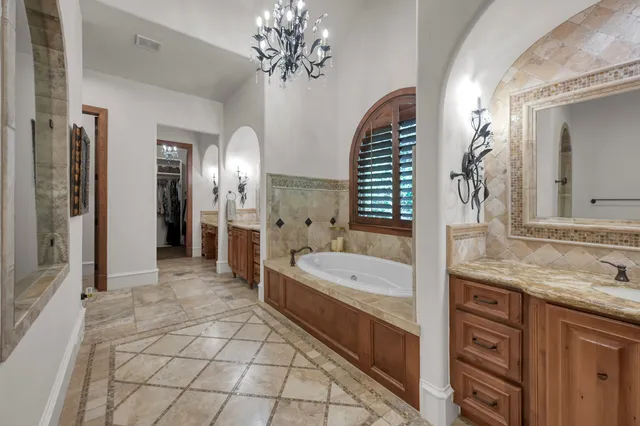 a spacious bathroom with a granite countertop sink and a mirror